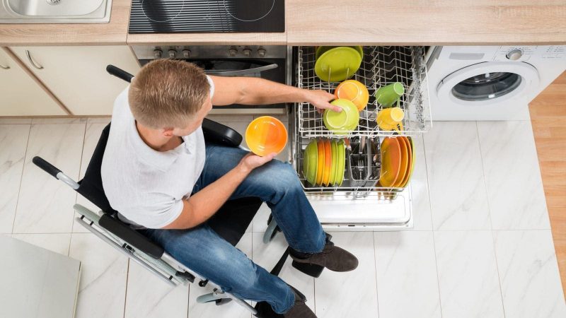 High Angle View Of Young Disabled Man In Kitchen