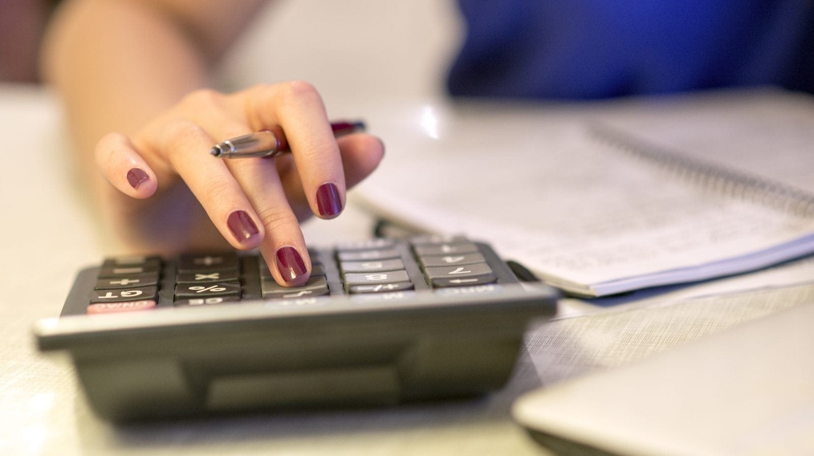 Close up of female accountant or banker making calculations