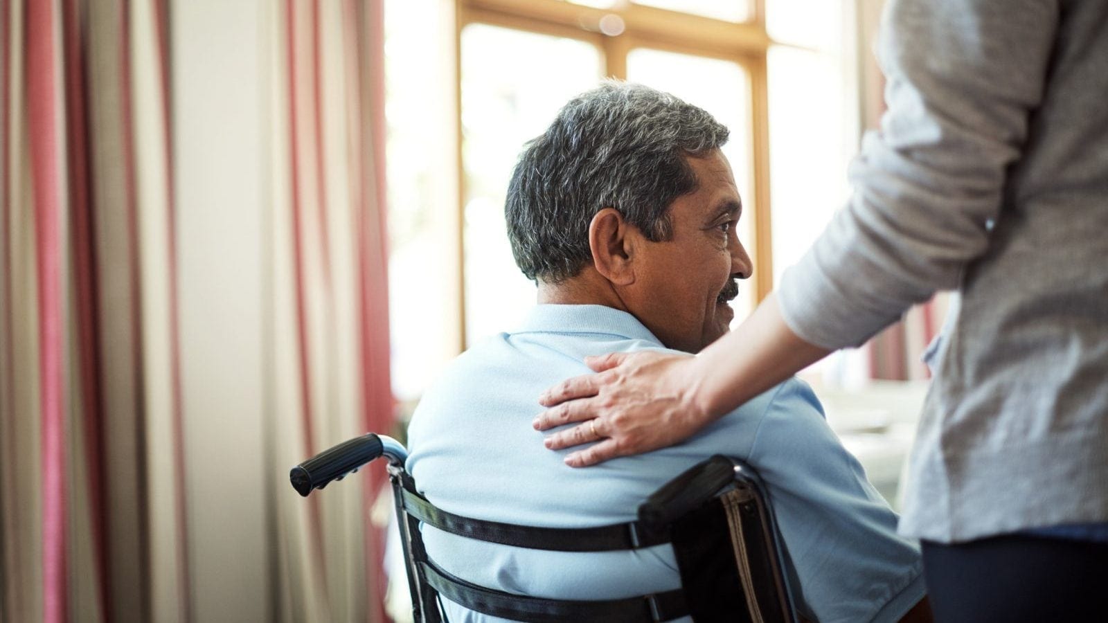 Shot of a young nurse caring for a senior man in a retirement home