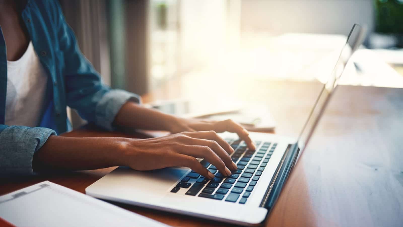 Woman Working On A Laptop Computer Stock Photo