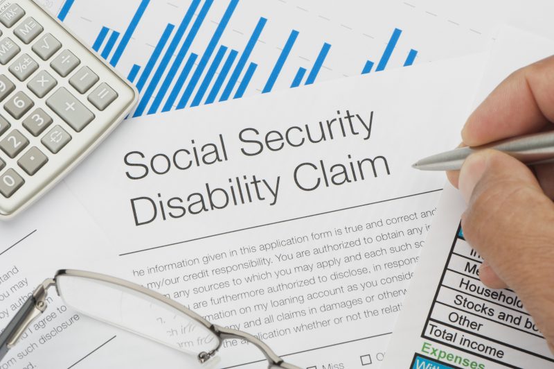 A person in Los Angeles filling out a social security disability claim with the help of a Disability Lawyer