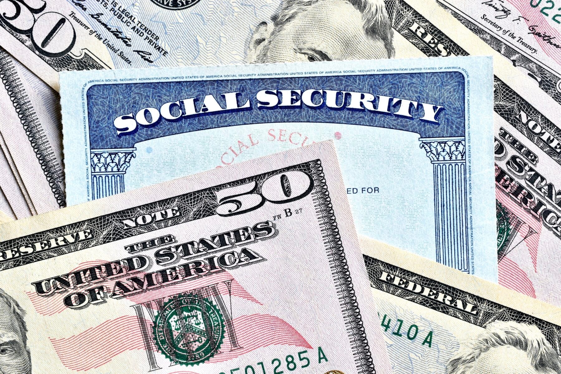A social security card surrounded by $50 bills.